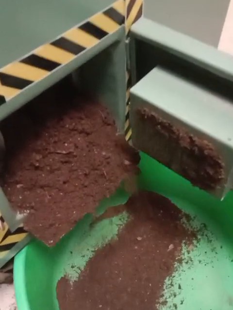 Finished compost discharging from a TGMC composter into a tub at a private residence in Kolkata